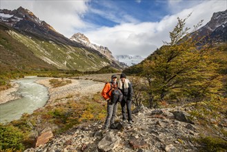 Argentina, Santa Cruz, El Chalten, Portrait of smiling hikers standing near Electrico River, El