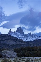 Argentina, Santa Cruz, El Chalten, Clouds above snow covered Mount Fitz Roy at sunset, El Chalten,