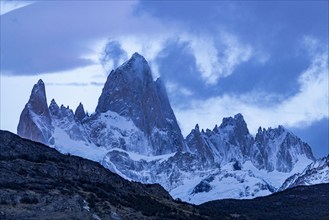 Argentina, Santa Cruz, El Chalten, Clouds above snow covered Mount Fitz Roy at sunset, El Chalten,