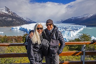 Argentina, Santa Cruz, El Calafate, Portrait of smiling couple at Perito Moreno Glacier, El