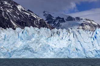 Argentina, Santa Cruz, El Calafate, Perito Moreno glacier ice formations with water in foreground,