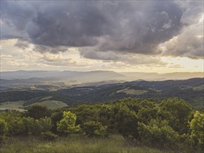 USA, Virginia, Newport, Storm clouds over hilly landscape at sunset, Newport, Virginia, USA