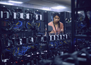 Female technician working in server room 
St, George, Utah, USA