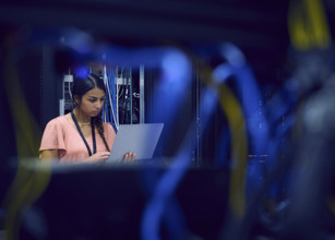 Female technician using laptop in server room 
St, George, Utah, USA