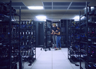 Technicians using computer in server room 
St, George, Utah, USA