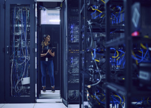 Female technician standing in server room 
St, George, Utah, USA