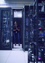 Female technician standing in server room 
St, George, Utah, USA