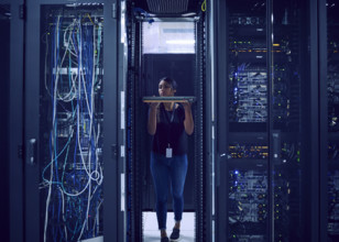 Female technician holding hard drive in server room
St, George, Utah, USA