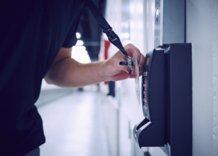 Close-up of employee using keycard and digital door lock in server room
St, George, Utah, USA