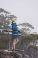 Female hiker in jacket and baseball cap standing on observation point
Katoomba, New South Wales,