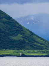 Low clouds covering mountains seen across water
Kodiak Island, Alaska, USA