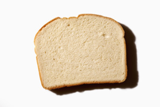 Overhead view of slice of white bread on white background
New York City, NY USA