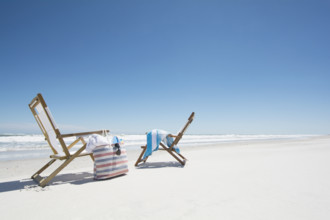 Two deck chairs, beach bag and beach towel on beach
Hampstead, North Carolina, USA