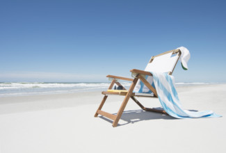 Empty chair with beach towel and baseball cap on beach
Hampstead, North Carolina, USA