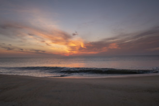 Sunrise over calm sea and sandy beach
Nags Head, North Carolina, USA