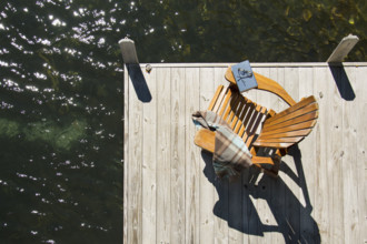 Overhead view of adirondack chair with book and blanket on pier on Lake Placid
Lake Placid, New