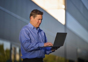 Man working on laptop outdoors