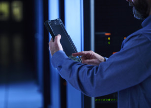 Close-up of man using tablet in data center
