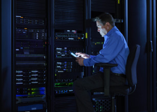 Man using digital tablet in data center