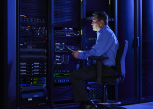 Man using digital tablet in data center