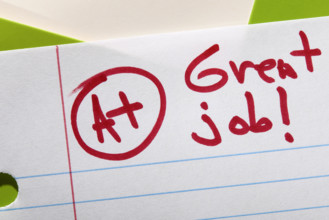 Close-up of A+ grade on lined paper