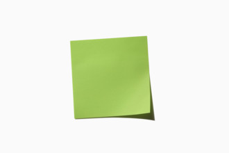 Green post it note on white background