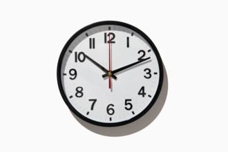 Studio shot of analog wall clock on white background