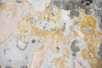 Close-up of textured peeling concrete wall