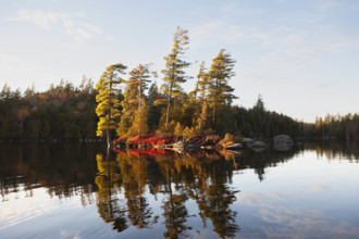USA, New York, Saranac Lake, Trees on islet on Upper Saranac Lake
