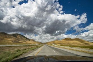 USA, Utah, Snowville, Empty road and clouds seen from car