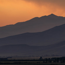 USA, Idaho, Bellevue, Silhouettes of hills against orange sky at sunset