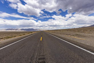 USA, Nevada, Henderson, Clouds over empty desert road