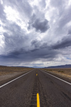 USA, Nevada, Henderson, Storm clouds over empty desert road