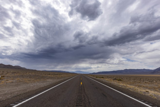 USA, Nevada, Henderson, Storm clouds over empty desert road