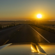 USA, California, Paso Robles, Sun rising above empty California State Route 46