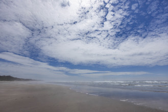 USA, Oregon, Newport, White puffy clouds above empty beach