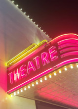 Illuminated theater marquee at night
