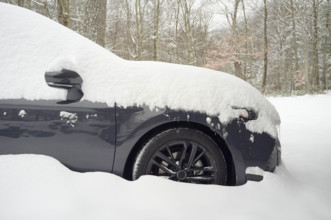 Car covered with fresh deep snow