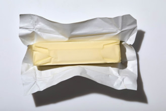 Overhead view of stick of butter on white background