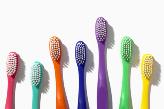 Colorful toothbrushes on white background