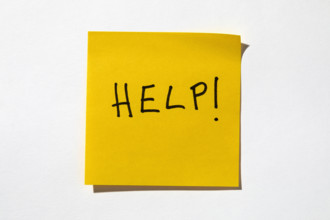 Help written on yellow post it note