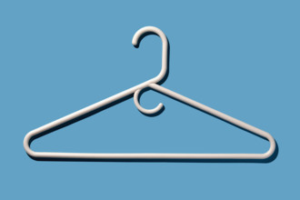 White coat hanger on blue background