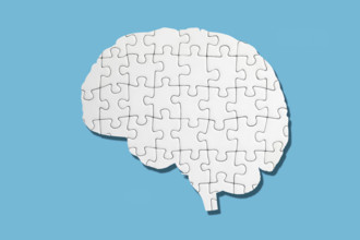 White brain shaped puzzle on blue background