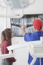 Dentist explaining X-ray to female patient