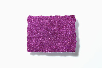 Torn pink glitter paper on white background