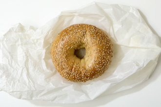 Overhead view of bagel on white background