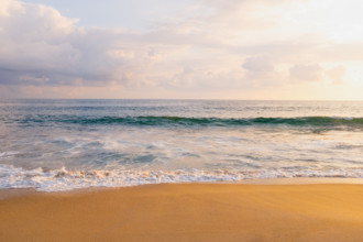 Mexico, Oaxaca State, Puerto Escondido, Costa Chica, Clouds over ocean waves on empty beach
