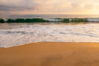 Mexico, Oaxaca State, Puerto Escondido, Costa Chica, Clouds over ocean waves on empty beach at