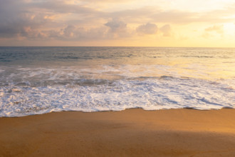 Mexico, Oaxaca State, Puerto Escondido, Costa Chica, Clouds over ocean waves on empty beach at
