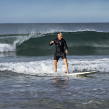 Costa Rica, Guanacaste, Playa Grande, Senior man surfing on sea wave